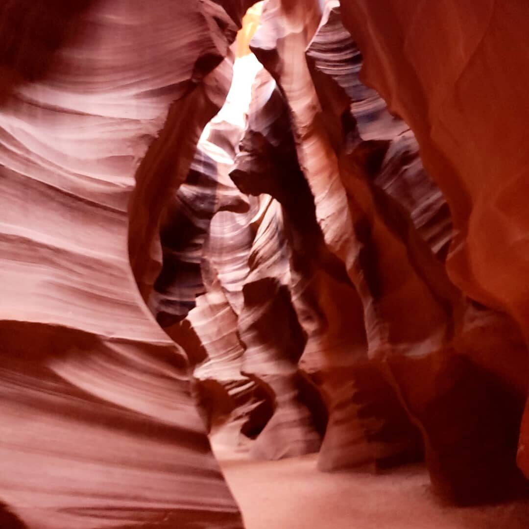 Narrow sandstone canyon corridor with layered striations, Antelope Canyon, Arizona
